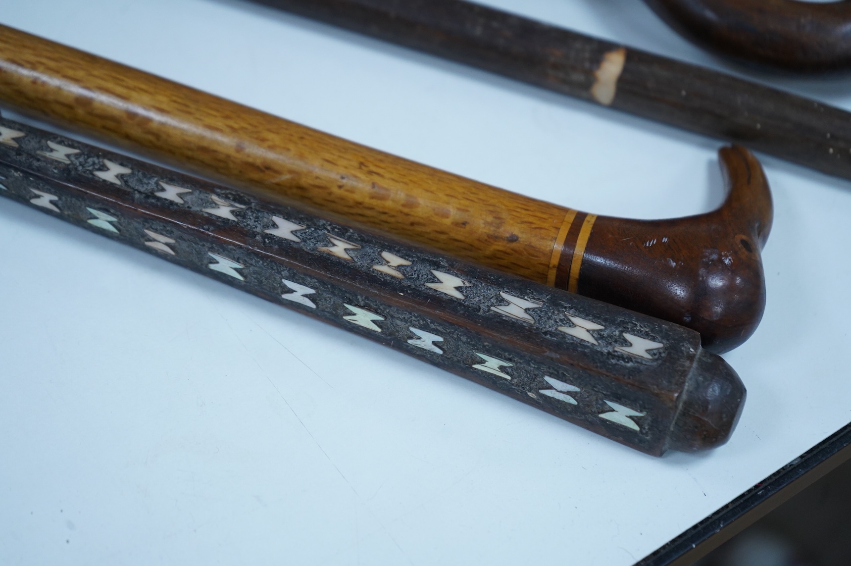 A collection of African and other walking sticks and walking canes - ebonised cane 105 cm long